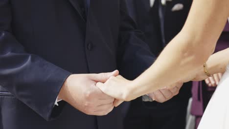 Bride and groom hold hands during ceremony