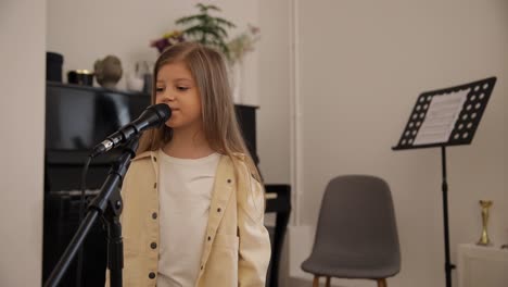 a young girl sings into a microphone at home displ 4k 2025 08 05 00 24 08 utc.mov | achievement, amateur, ambition, art