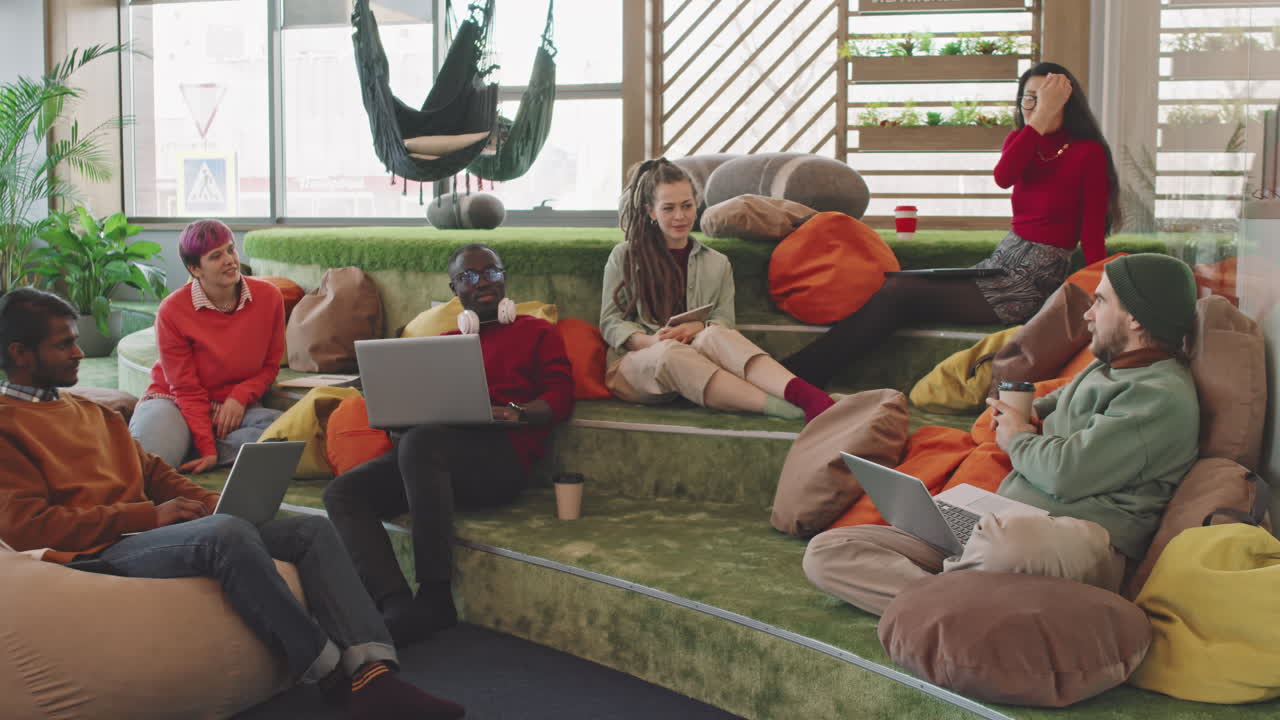 Team of People Talking about Project in Lounge of Start-Up Office