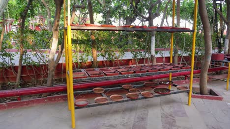 bird water drinking facility with clay pot filled with water at outdoor at evening