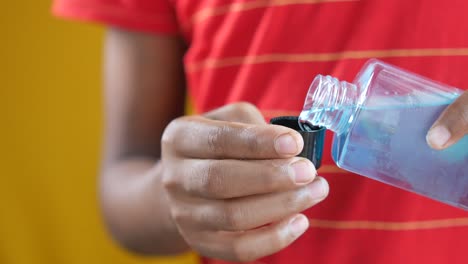 child pouring hand sanitizer