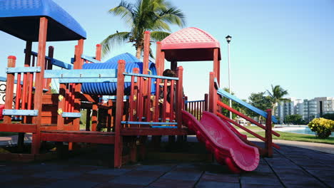 little girl playing on a colorful playground