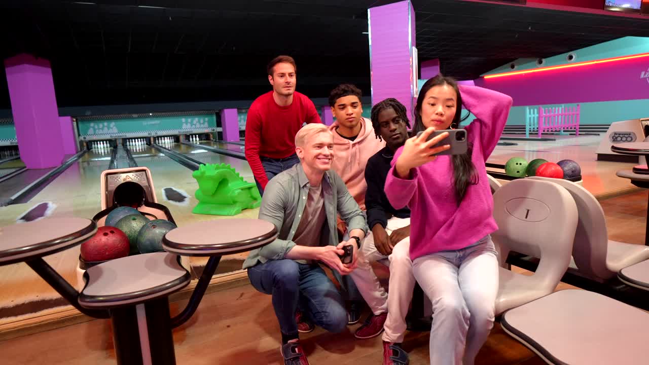 Group of friends taking a selfie at a bowling alley