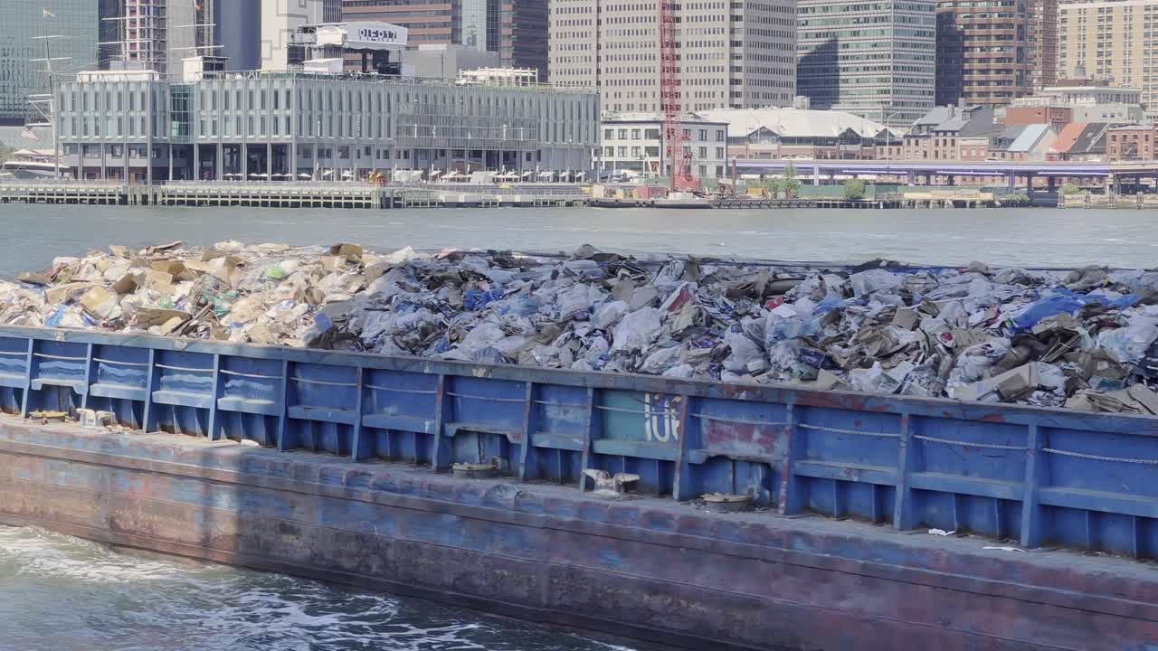 Trash barge transporting solid waste on East river in New York, USA
