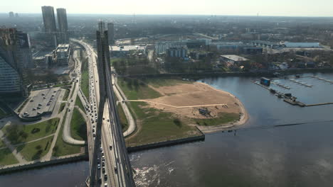 Aerial-panoramic-shot-from-above-Riga's-Vansu-bridge-over-Daugava-river,-near-oldtown