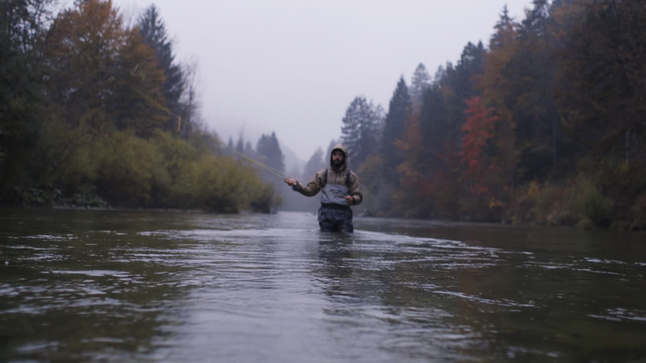 Man Fly Fishing in Autumn River