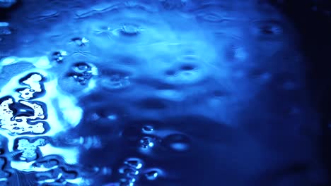 video of rainy drops on blue glass background