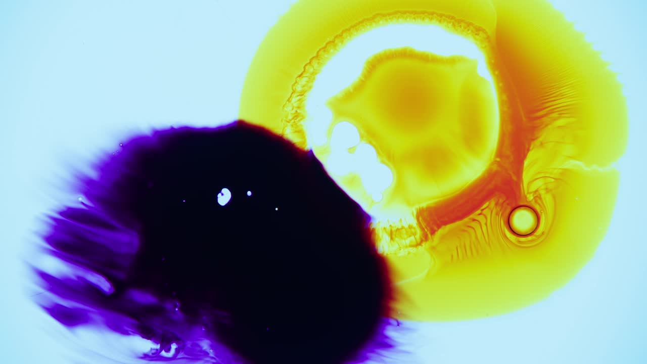 Yellow oil dye burst in Petri dish