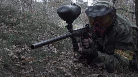 paintball player in a forest setting