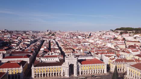 Drone-descending-from-high-altitude-with-Arco-da-Rua-Augusta-in-back-in-Lisbon-Portugal-Europe-on-a-bright-and-sunny-day