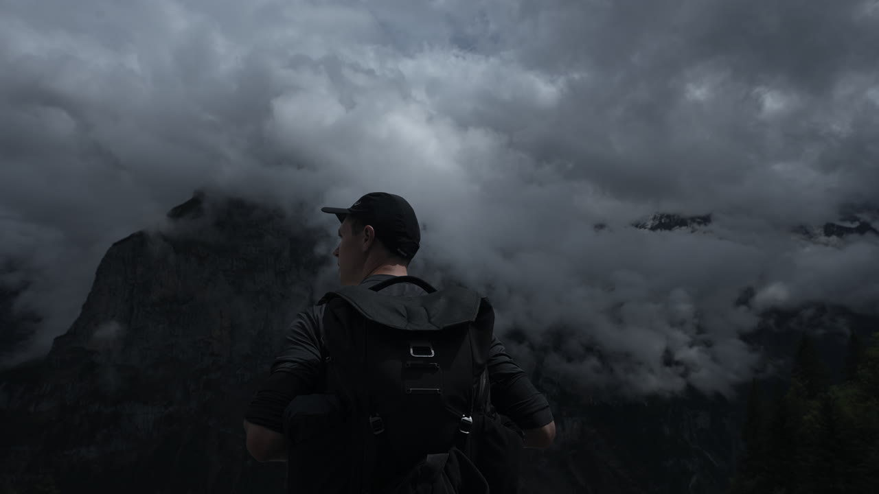 Hiker Gazing at Misty Mountain Peaks
