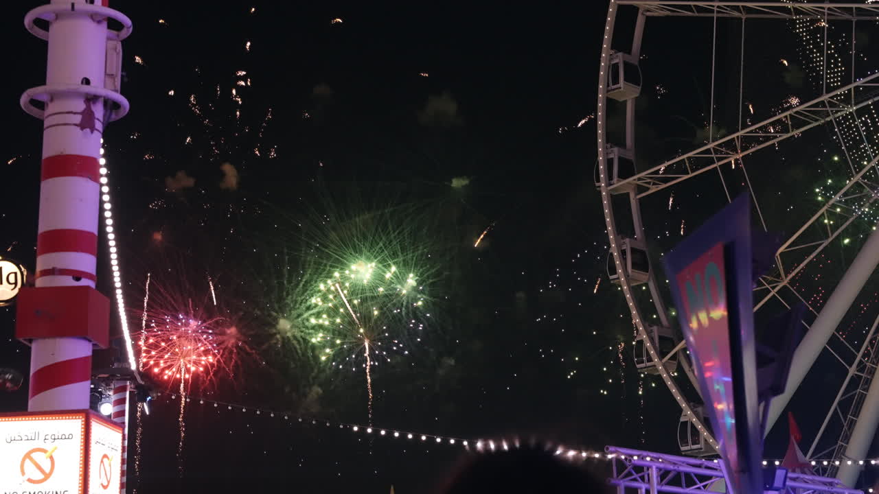 Fireworks Display at an Amusement Park at Night
