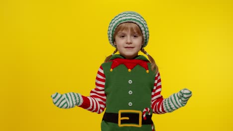 Kid-girl-in-Christmas-elf-Santa-helper-costume-dancing,-fooling-around.-New-Year-holiday-celebration