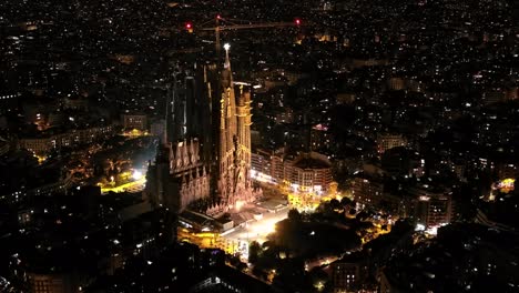 aerial view of barcelona eixample residential district and famous basilica sagrada familia at night. catalonia, spain