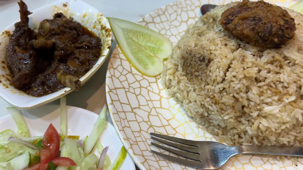 Traditional Bengali food, Basmati Kacchi Biryani and mutton kala bhuna at a restaurant in Dhaka.