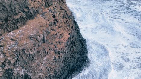 Vik-Black-beach-drone-flying-towards-the-Reynisdrangar-and-panning-up