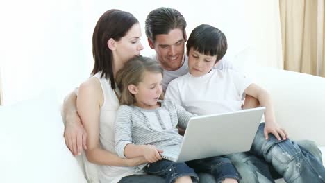 young family using a laptop at home