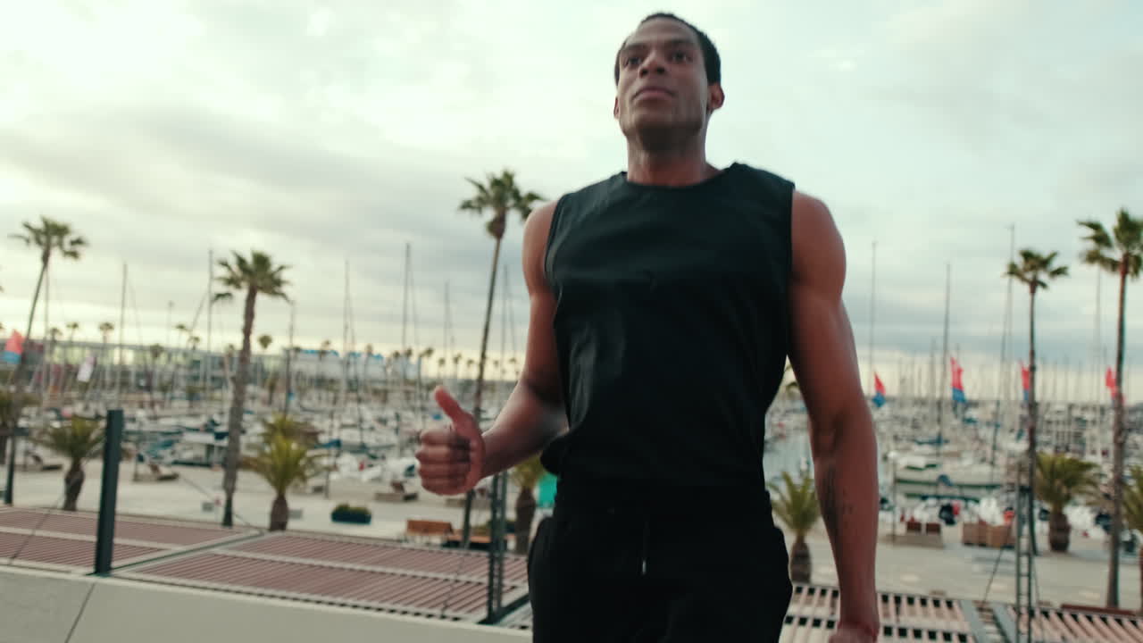 Young Man Jogging By The Marina