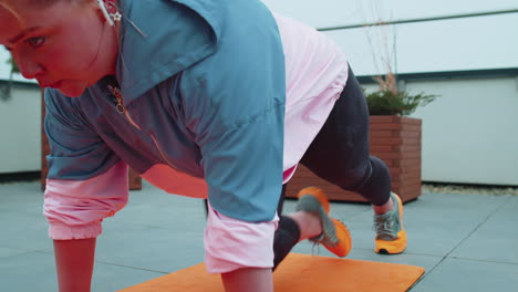 athletic sport girl doing running plank, cross fitness, bodybuilding training routine on rooftop