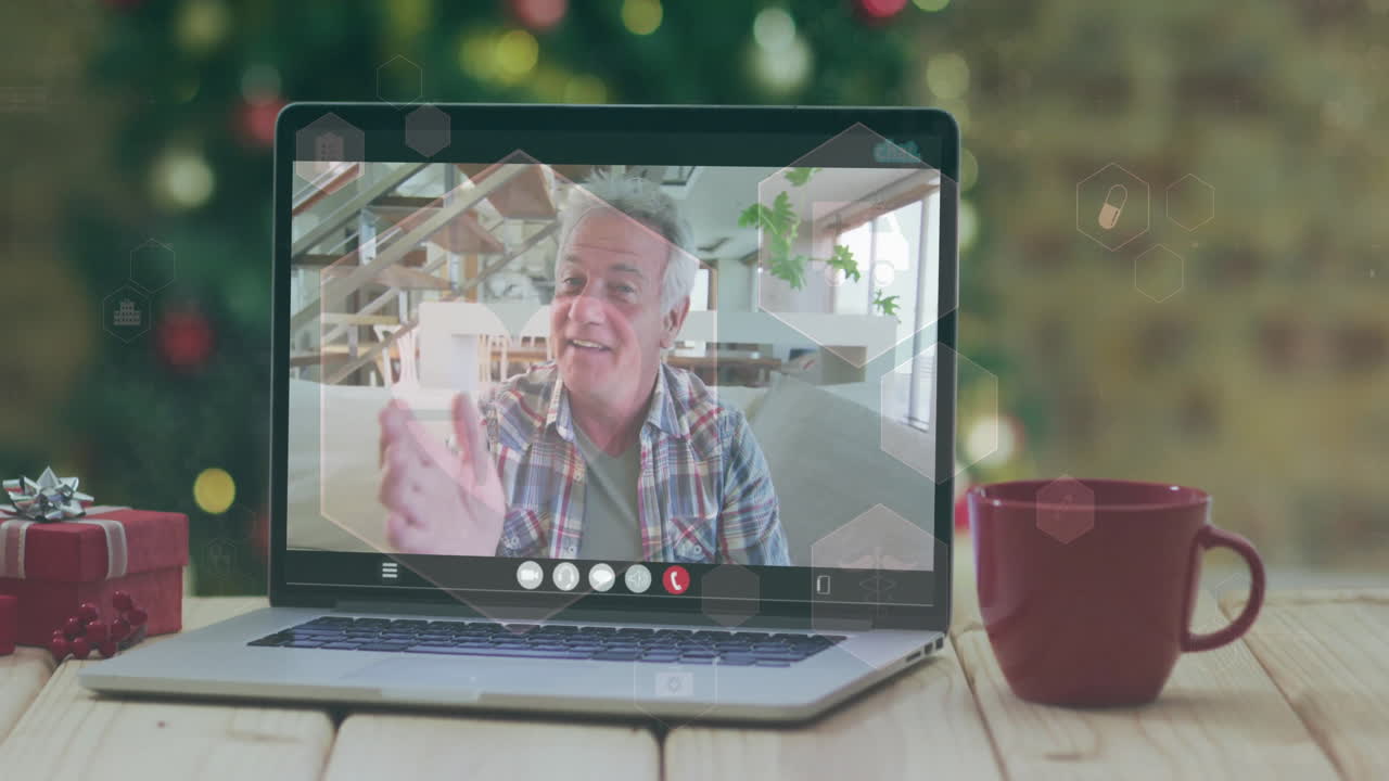 On video call, person smiling with festive decorations and coffee cup nearby