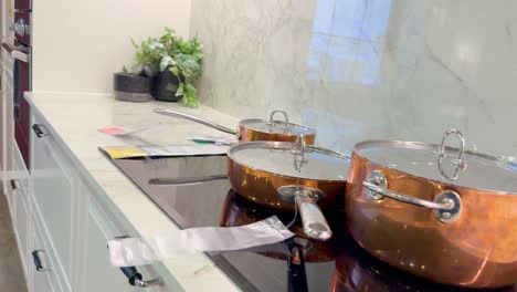 copper pots on stove in stylish kitchen