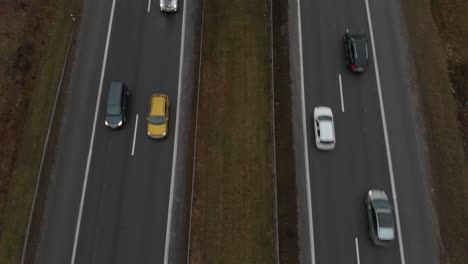 Top-down-traffic-jam-view-of-highway-people-driving-cars-on-a-busy-city-rush-hour-road,-slow-motion