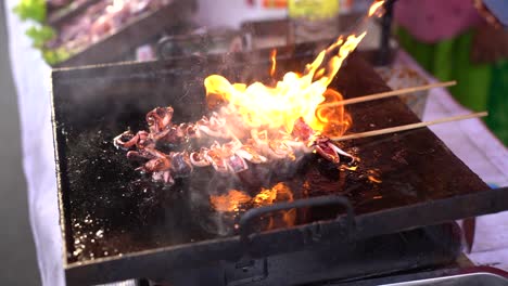 sate squid when the process is burned. grilled squid on skewers, good street food in night market or ramadhan market.