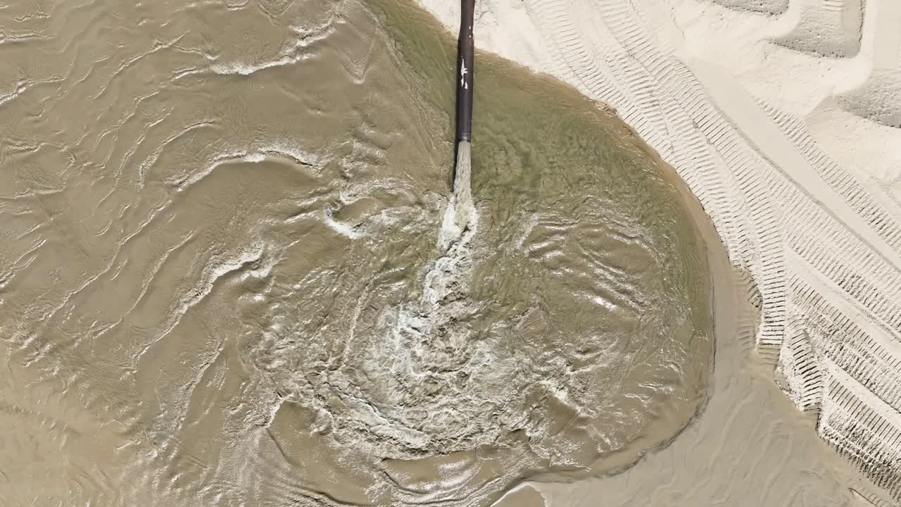 Direct aerial view with drone of a dredging beach process
