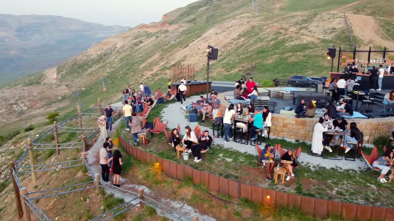 Frozen Cherry Bar Full Of Tourist At The Mountaintop In Mtein, Lebanon. aerial, orbit