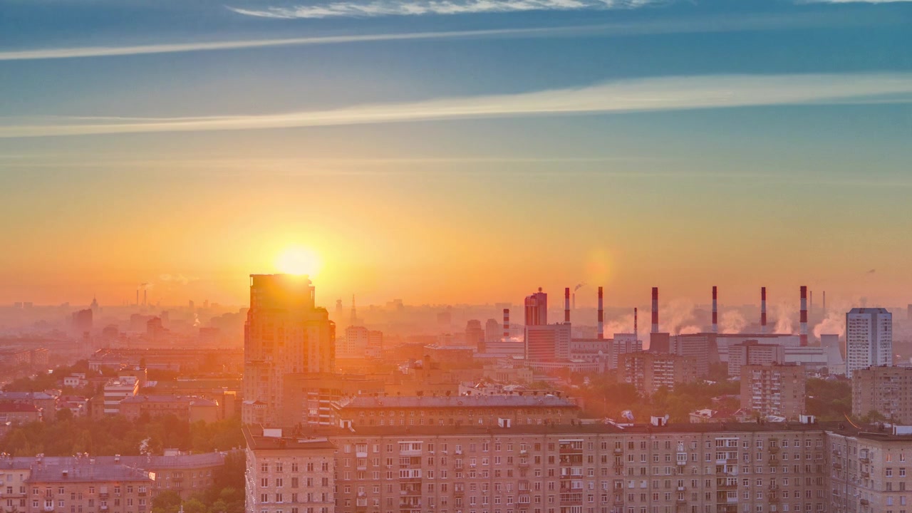 Residential buildings on Leninskiy avenue, Stalin skyscrapers, smoking pipes and panorama of city at sunrise timelapse in Moscow, Russia. Morning mist. Aerial view from rooftop