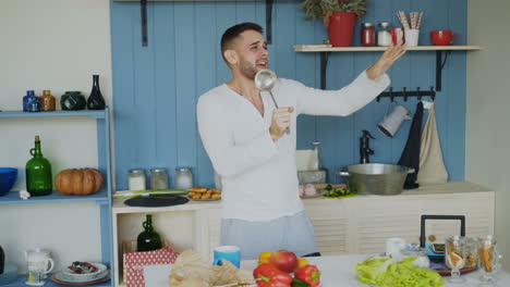 man singing and dancing in kitchen