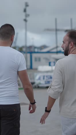two men walking in an urban outdoor setting