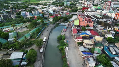 picturesque philippine village town and calm river with lush foliage and colorful rooftops in virac, catanduanes