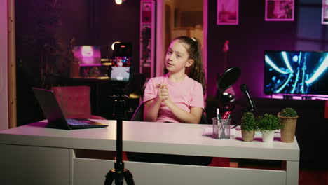 Kid-talking-about-her-experiences-growing-up,-filming-content-for-social-media-with-smartphone
