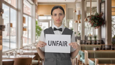 sad indian woman waiter holding unfair banner