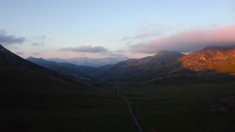 a lonely road leading into distant mountains in a beautiful reserve as seen from above