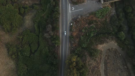 timelapse, drone top view tracking road with cars driving, establishing shot
