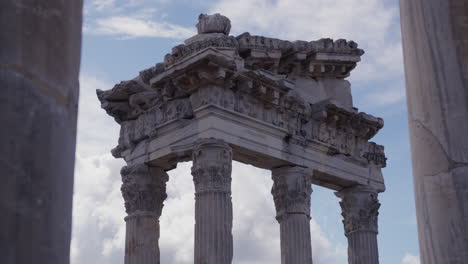 the ruins of the temple of trajan through a row of pillars in pergamum