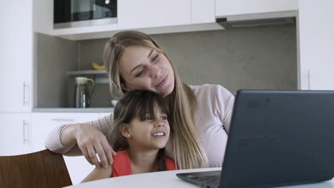 Cute-little-girl-and-her-mom-watching-content