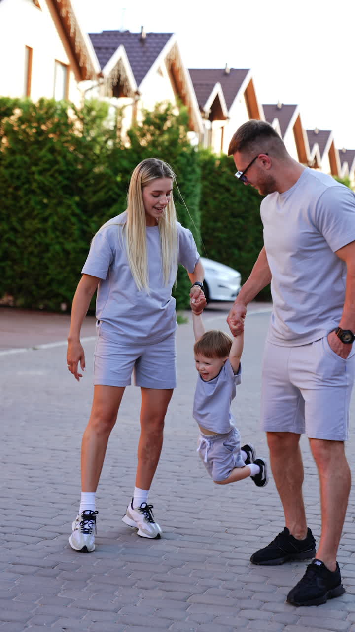 Kyiv, Ukraine, 25 May 2025: Family enjoys an evening walk together. A family strolls along a paved path in the evening, enjoying time together while dressed in matching outfits