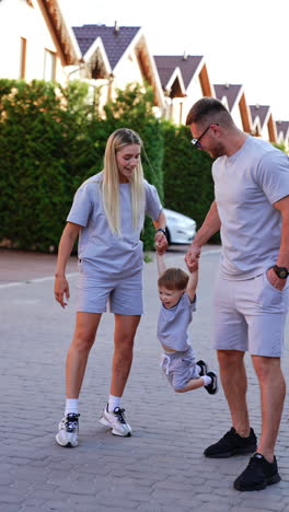 kyiv, ukraine, 25 may 2025: family enjoys an evening walk together. a family strolls along a paved path in the evening, enjoying time together while dressed in matching outfits