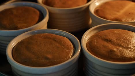 close up of chocolate mousse in baking dishes