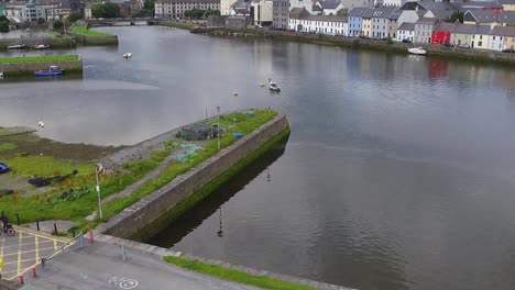 aerial closeup shot of wolfe tone bridge, galway cathedral and the claddagh with the spanish arch, panning up