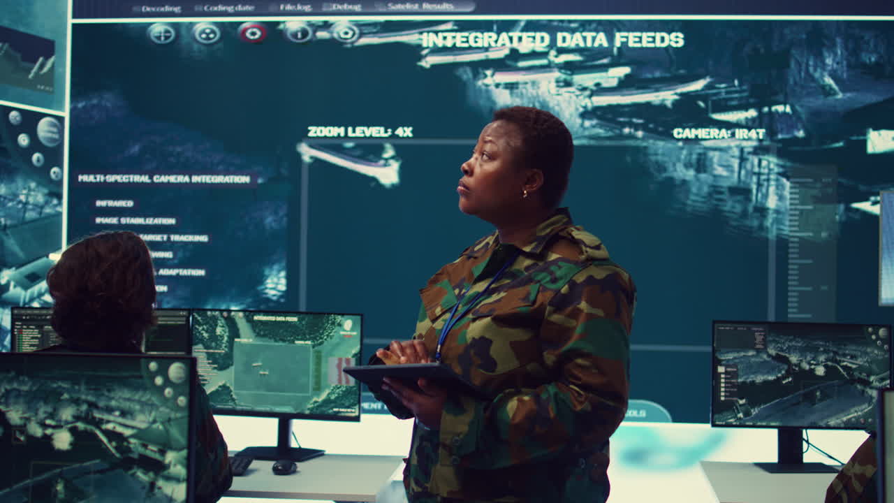 Woman high tech specialist studying satellite CCTV visualization on a big screen