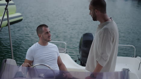 two men conversing on a boat