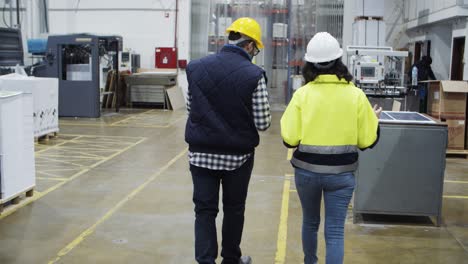 Back-view-of-factory-employees-walking-at-factory