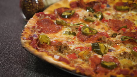 classic thin crust pepperoni pizza with jalapenos, close up slider 4k