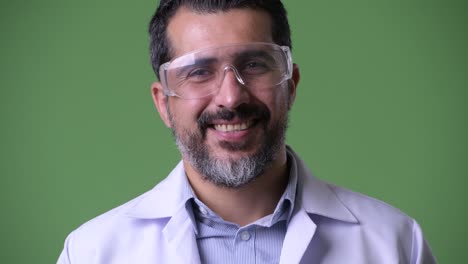 handsome persian bearded man doctor wearing protective glasses