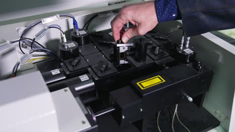 man's hand takes out a part of medical equipment. technological devices for conducting research experiments in medical laboratory. close up with gradual distancing.