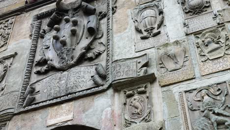 stone coats of arms on the facade of pretorio palace at via dei pileati in tuscany, italy